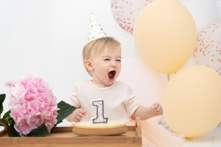 adorable pretty happy caucasian blonde baby girl screaming celebrating first year