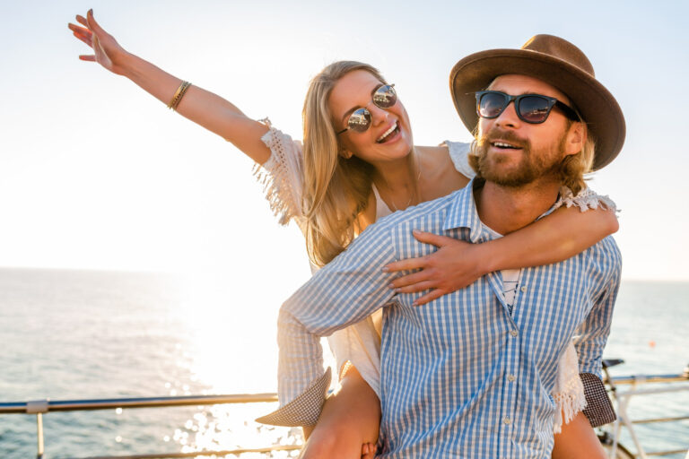attractive happy couple laughing traveling summer by sea man woman wearing sunglasses