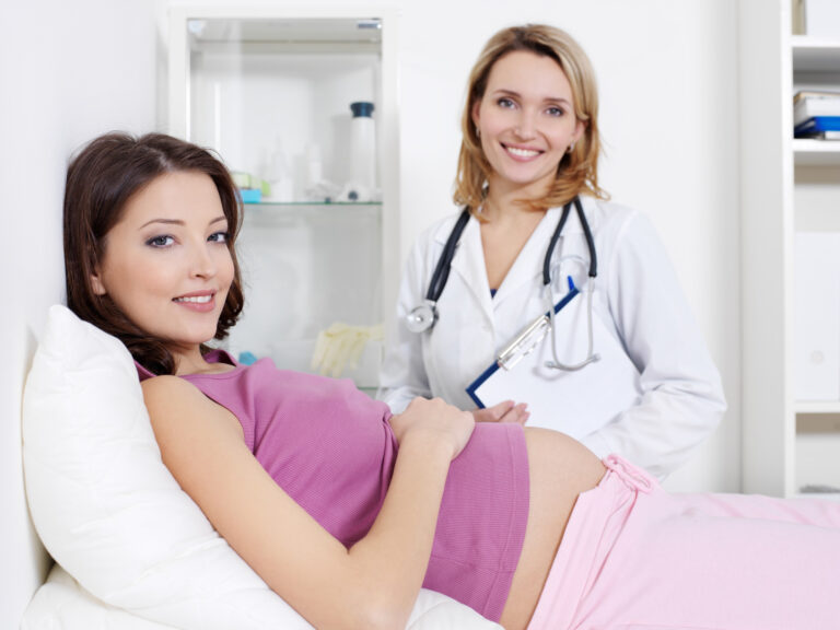 happy young pregnant woman her doctor hospital