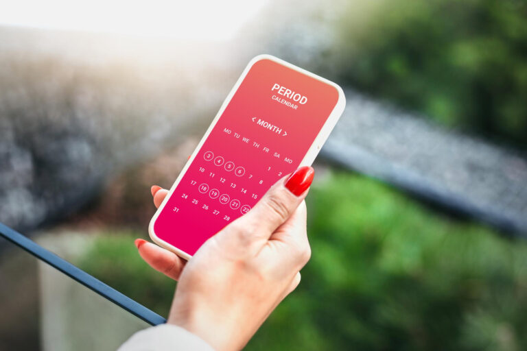 menstruation calendar woman tracking periods by using menstrual calendar app phone